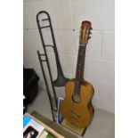 AN E.F. ALLEN & SONS TROMBONE MISSING THE MOUTHPIECE AND A GERMAN ACOUSTIC GUITAR, both