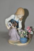 A LLADRO FIGURE WATERING THE FLOWER POTS, MODEL NO. 1376, sculpted by Juan Huerta, issued 1978-1990,