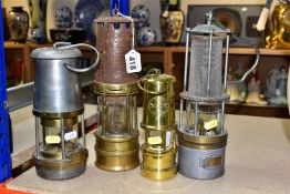 A GROUP OF FOUR MINER'S LAMPS, comprising a brass and steel miner's lamp stamped 109, height 26cm (