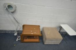 A MAGNIFYING LAMP, with an angle poise style arm, a two tier trolley, a beige footstool, and a white