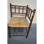 A VICTORIAN MAHOGANY BOBBIN TURNED CORNER CHAIR, with a rush seat, 42cm squared x height 68cm (