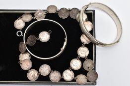 TWO BANGLES AND A COIN NECKLACE, to include a silver hinged bangle with scroll engraved detail and