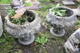 A PAIR OF COMPOSITE TWO PIECE GARDEN URNS with foliate detail to bowl and base height 33cm and a