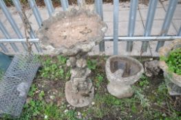 TWO COMPOSITE BIRD BATHS one in the form of an oyster shell on top of a tree stump height, 70cm