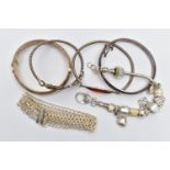 TWO SILVER BANGLES AND ASSORTED WHITE METAL BRACELETS, the first a hinged bangle with floral