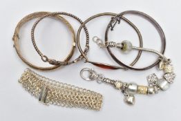 TWO SILVER BANGLES AND ASSORTED WHITE METAL BRACELETS, the first a hinged bangle with floral