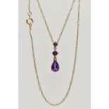 A YELLOW METAL AMETHYST AND DIAMOND PENDANT NECKLACE, the pendant set with a pear cut amethyst and