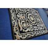 A G.H.FRITH CHINESE HANDKNOTTED BLACK GROUND RUG with brown and beige foliate detailing and a