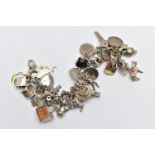 A WHITE METAL CHARM BRACELET, curb link chain fitted with fifty-two charms in form such as a teapot,