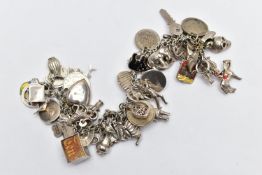A WHITE METAL CHARM BRACELET, curb link chain fitted with fifty-two charms in form such as a teapot,