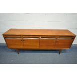AN ALFRED COX MID CENTURY TEAK AND WALNUT SIDEBOARD, with four drawers above four cupboard doors,