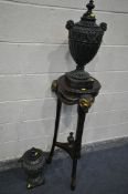 A MAHOGANY TORCHERE STAND, with three painted rams heads and central finial, on hoof style feet,