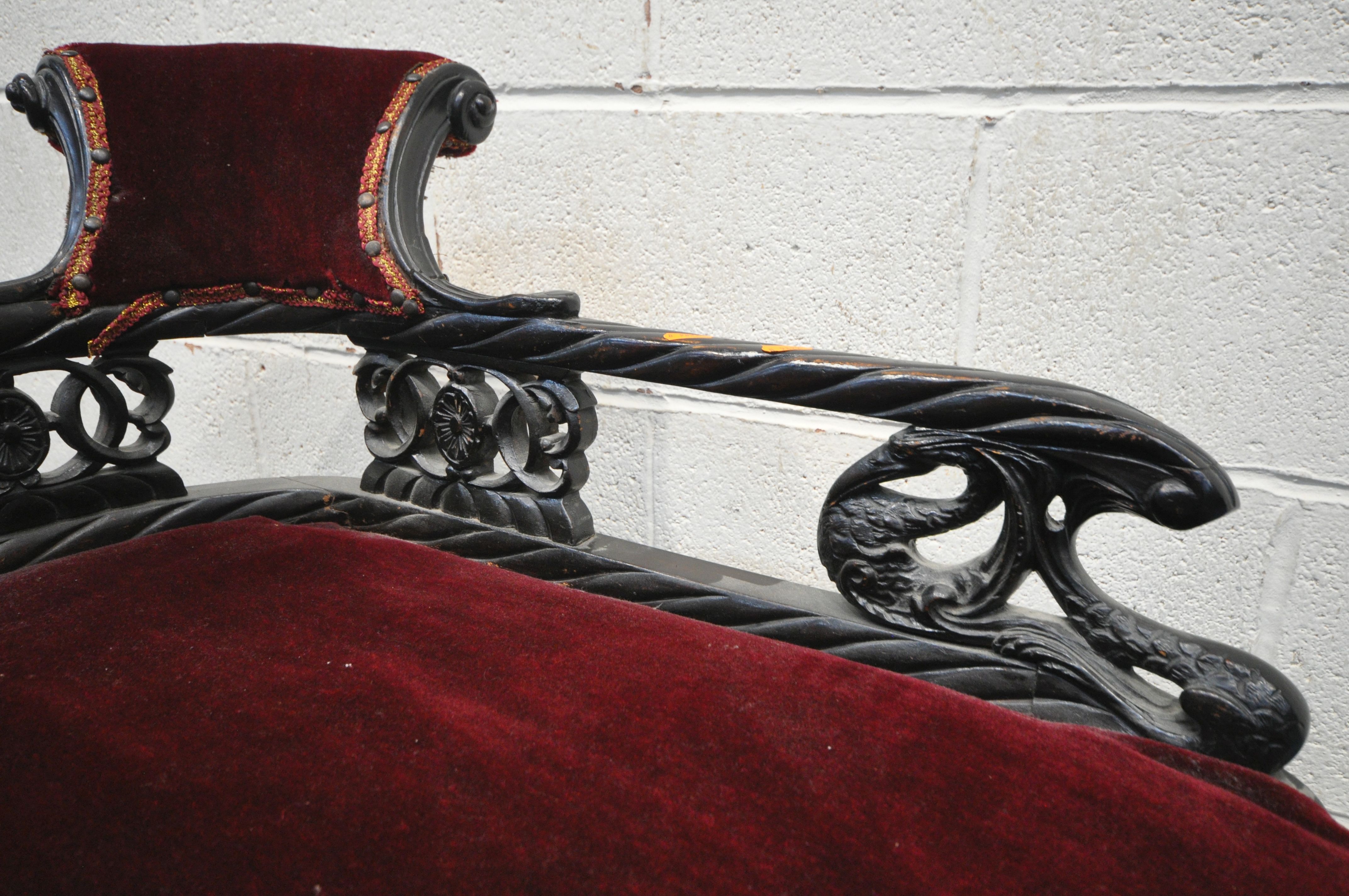 A 19TH CENTURY EBONISED CARVED WOOD SERPENTINE CHAISE LONGUE, of small proportions, having a - Image 3 of 4