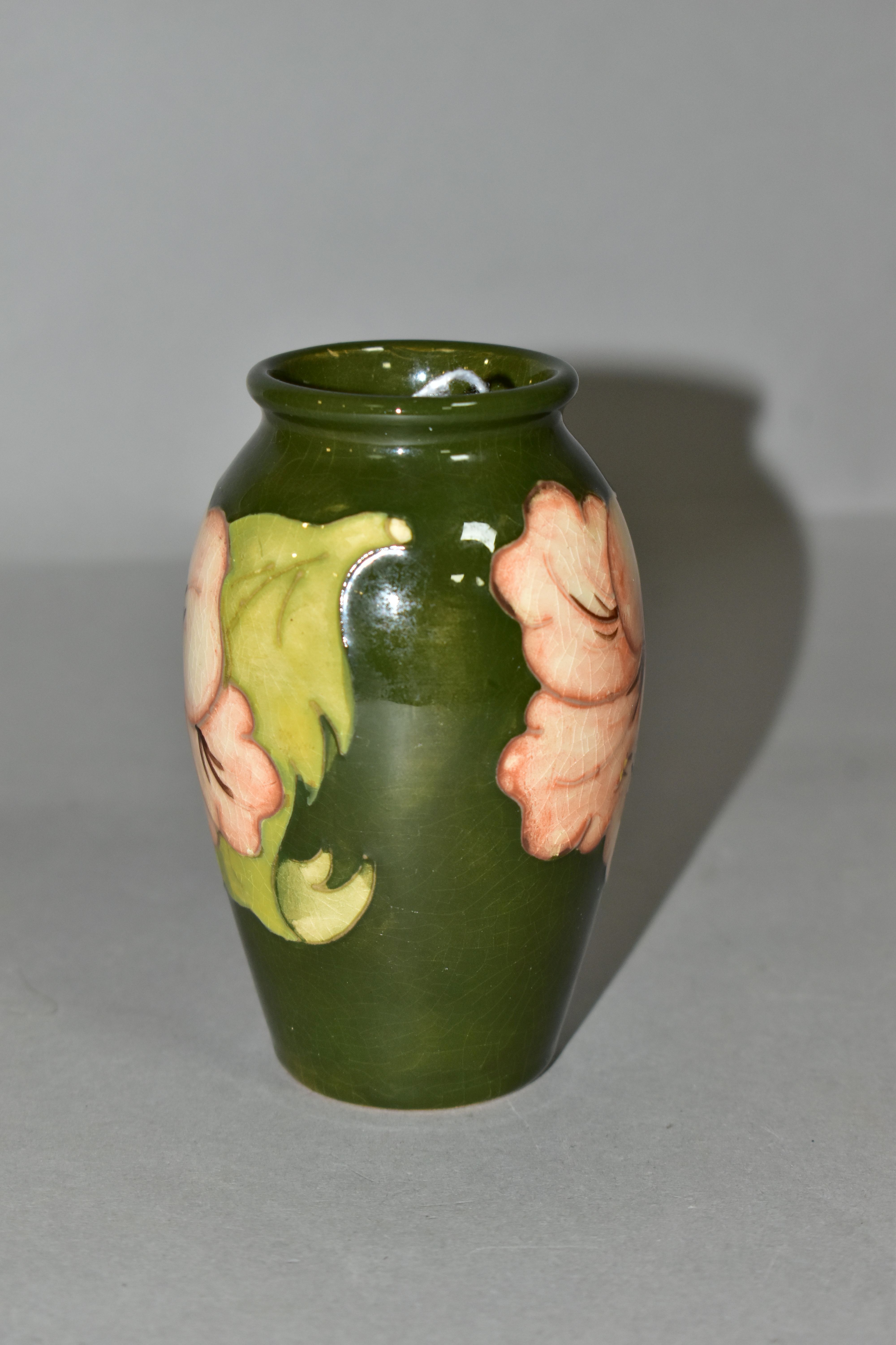 A MOORCROFT POTTERY BALUSTER SHAPED BUD VASE DECORATED WITH CORAL HIBISCUS ON A GREEN GROUND, - Image 2 of 4