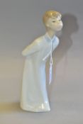 A LLADRO BOY BLOWING FIGURINE, model no 4869, sculpted by Fulgencio Garcia, issued 1974 and