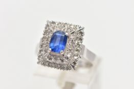 A SAPPHIRE AND DIAMOND CLUSTER RING, set with a rectangular cushion shape sapphire, measuring