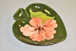 A MOORCROFT POTTERY PINK HIBISCUS TRINKET DISH, in the form of a spade, with tubelined pink hibiscus