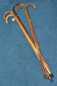 A GROUP OF FIVE WALKING STICKS, comprising three canes with silver tipped handles c1895, one has a