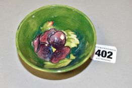 A MOORCROFT POTTERY SMALL FOOTED BOWL, of conical form, in Pansy pattern on a turquoise/green