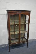AN EDWARDIAN MAHOGANY TWO DOOR DISLAY CABINET with astragal glazed door, strung and banded detail,