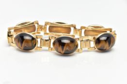 A YELLOW METAL AND TIGERS EYE BRACELET, comprised of six links each set with oval tigers eye