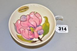 A MOORCROFT POTTERY MAGNOLIA FOOTED BOWL, with tubelined pink magnolia pattern to interior on a