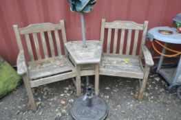 AN OAK GARDEN ANGLED BENCH with two seats separated by and angled shelf width at back 170cm