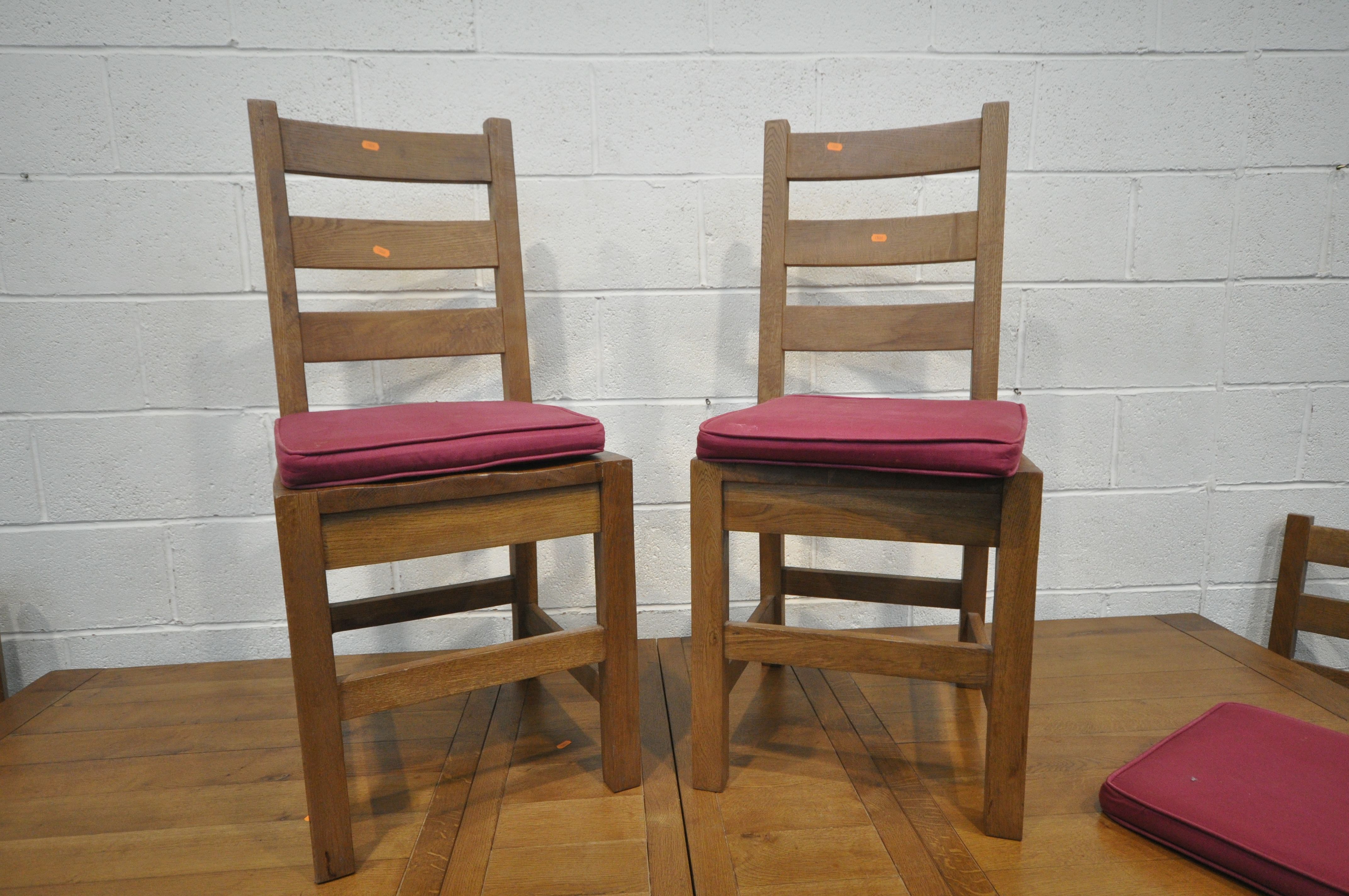 A MODERN LARGE OAK EXTENDING DINING TABLE standing on block legs, two extension leaves and six - Image 2 of 4