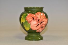 A MOORCROFT POTTERY PINK HIBISCUS VASE, of footed baluster form, with tubelined pink hibiscus