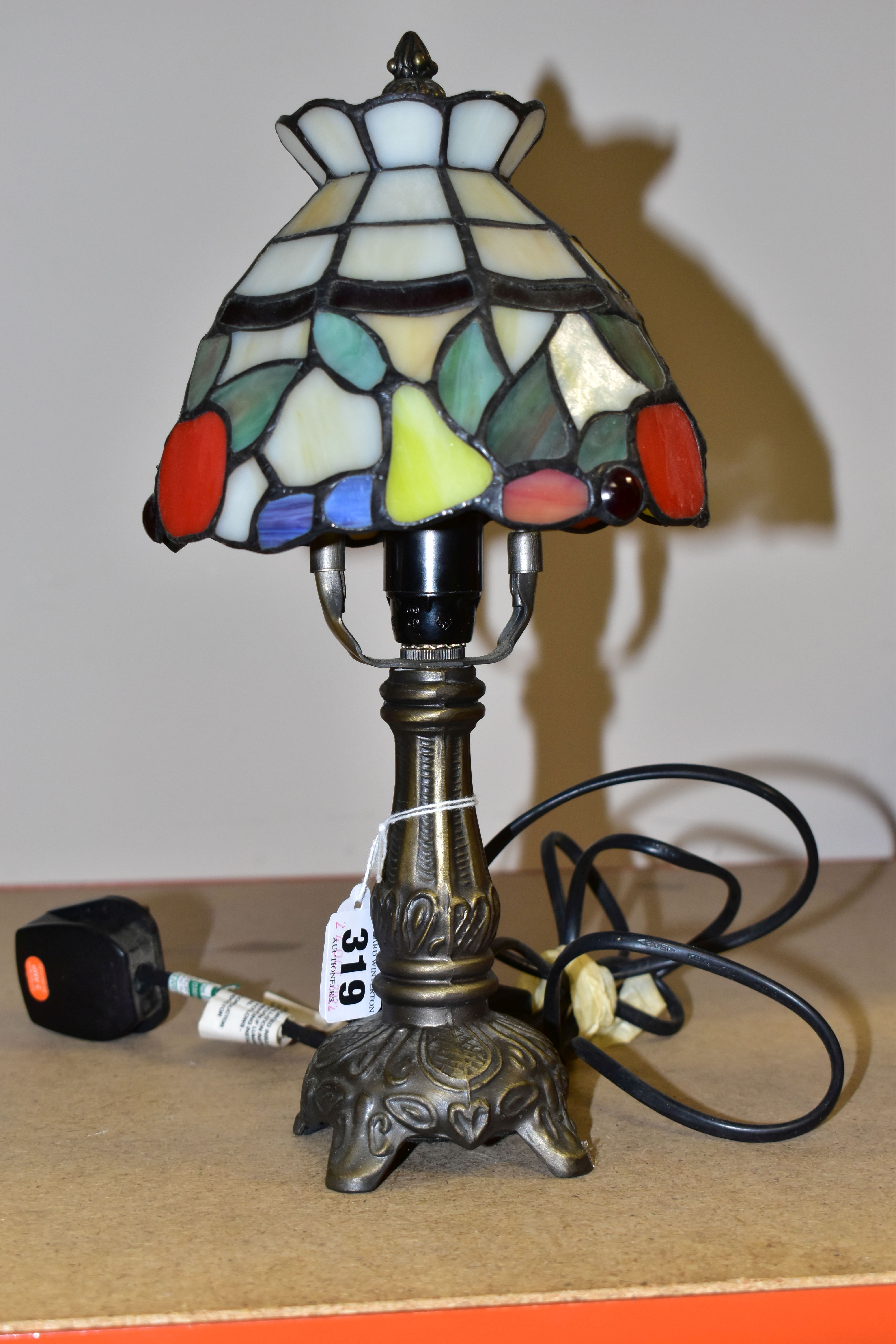 A SMALL TIFFANY STYLE TABLE LAMP, the glass shade is decorated with red apples and yellow pears,