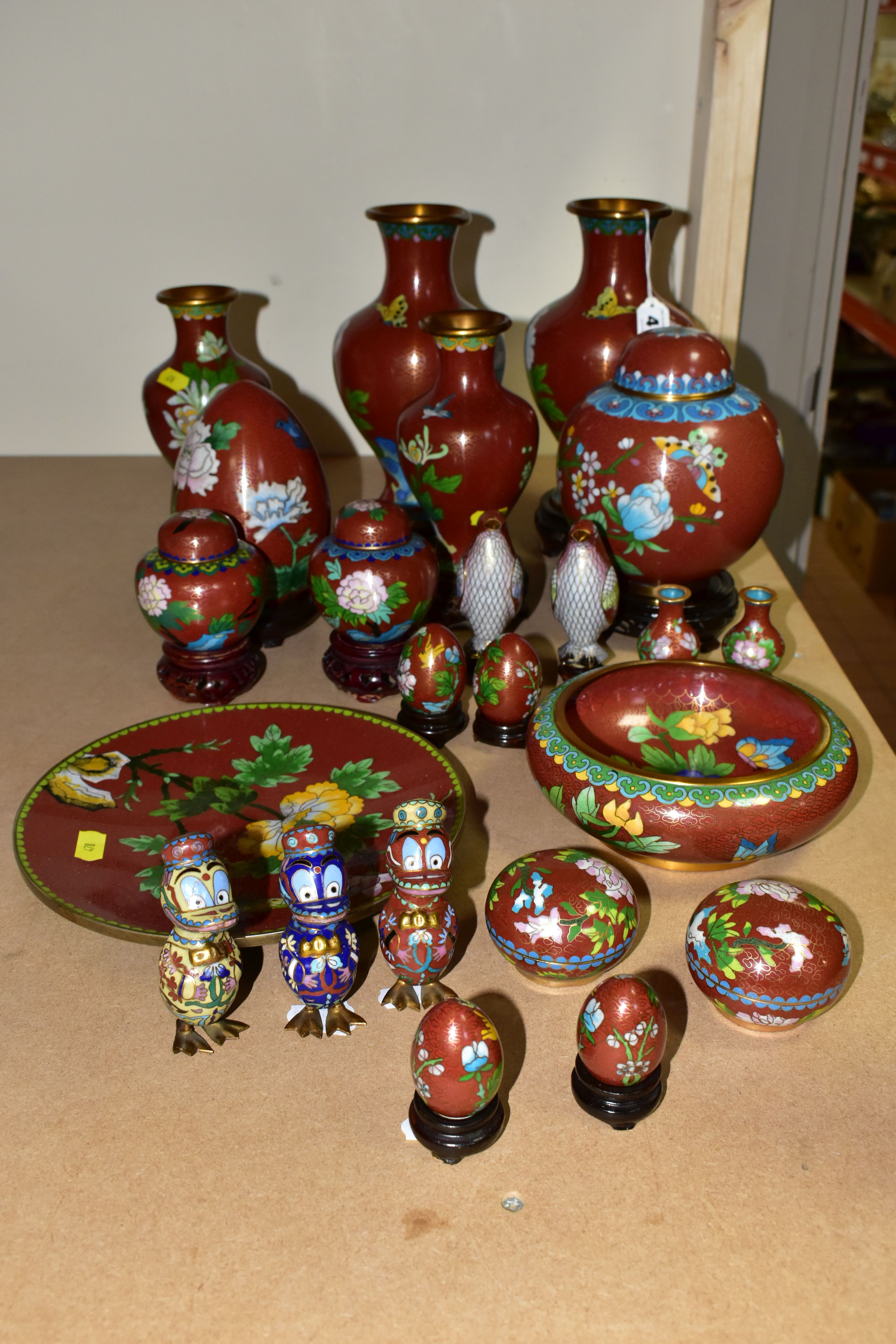 A COLLECTION OF MODERN CLOISONNÉ comprising four vases on wooden stands, a ginger jar, dish, bowl