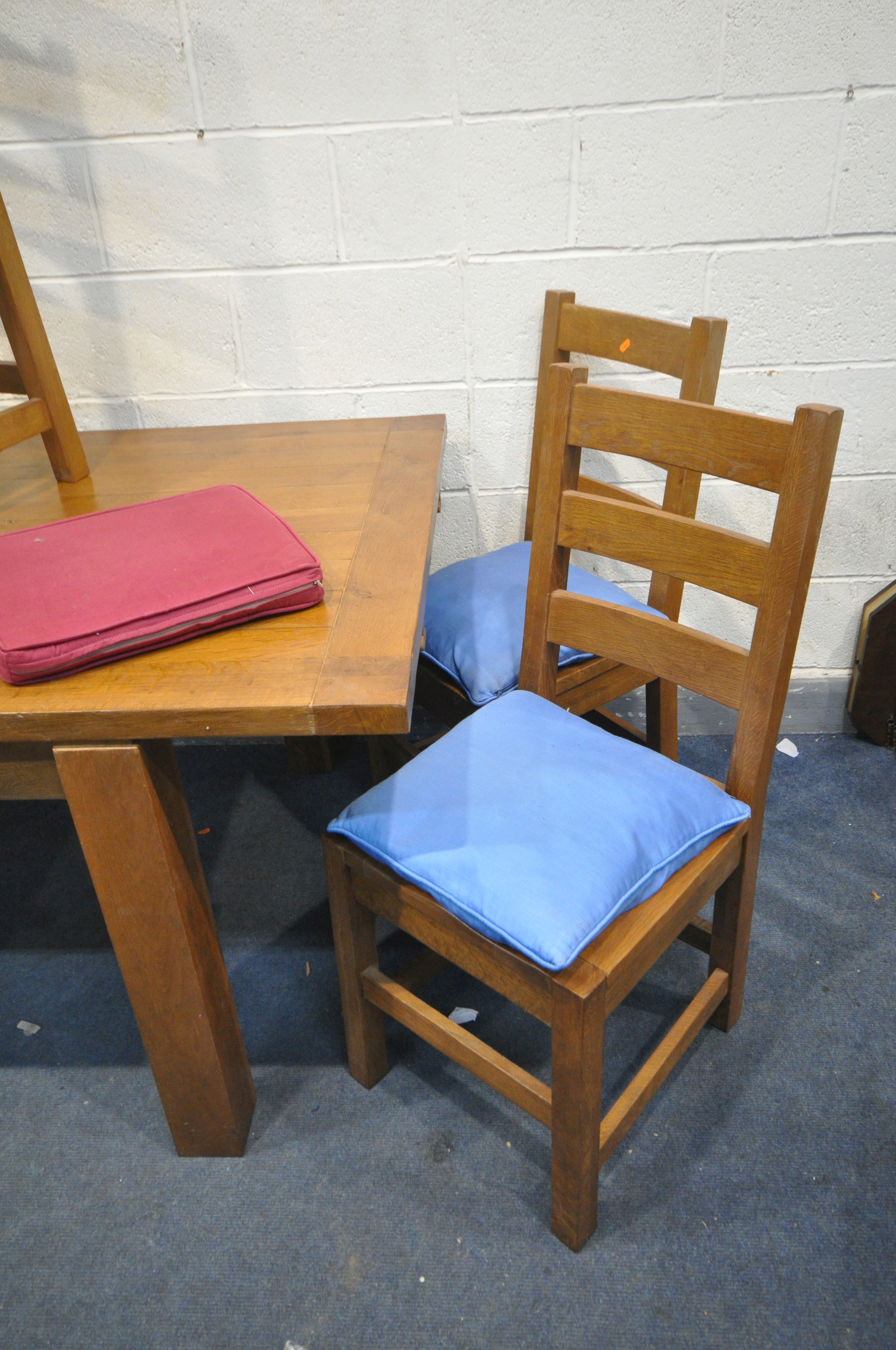 A MODERN LARGE OAK EXTENDING DINING TABLE standing on block legs, two extension leaves and six - Image 4 of 4