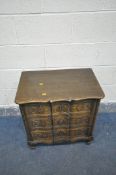 A MID 20th CENTURY SERPENTINE FRONT OAK CHEST OF THREE DRAWERS with shaped and carved drawer