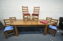 A MODERN LARGE OAK EXTENDING DINING TABLE standing on block legs, two extension leaves and six