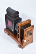 A 'KING ENLARGER' MAGIC LANTERN with an oak frame and tinplate body along with two covers