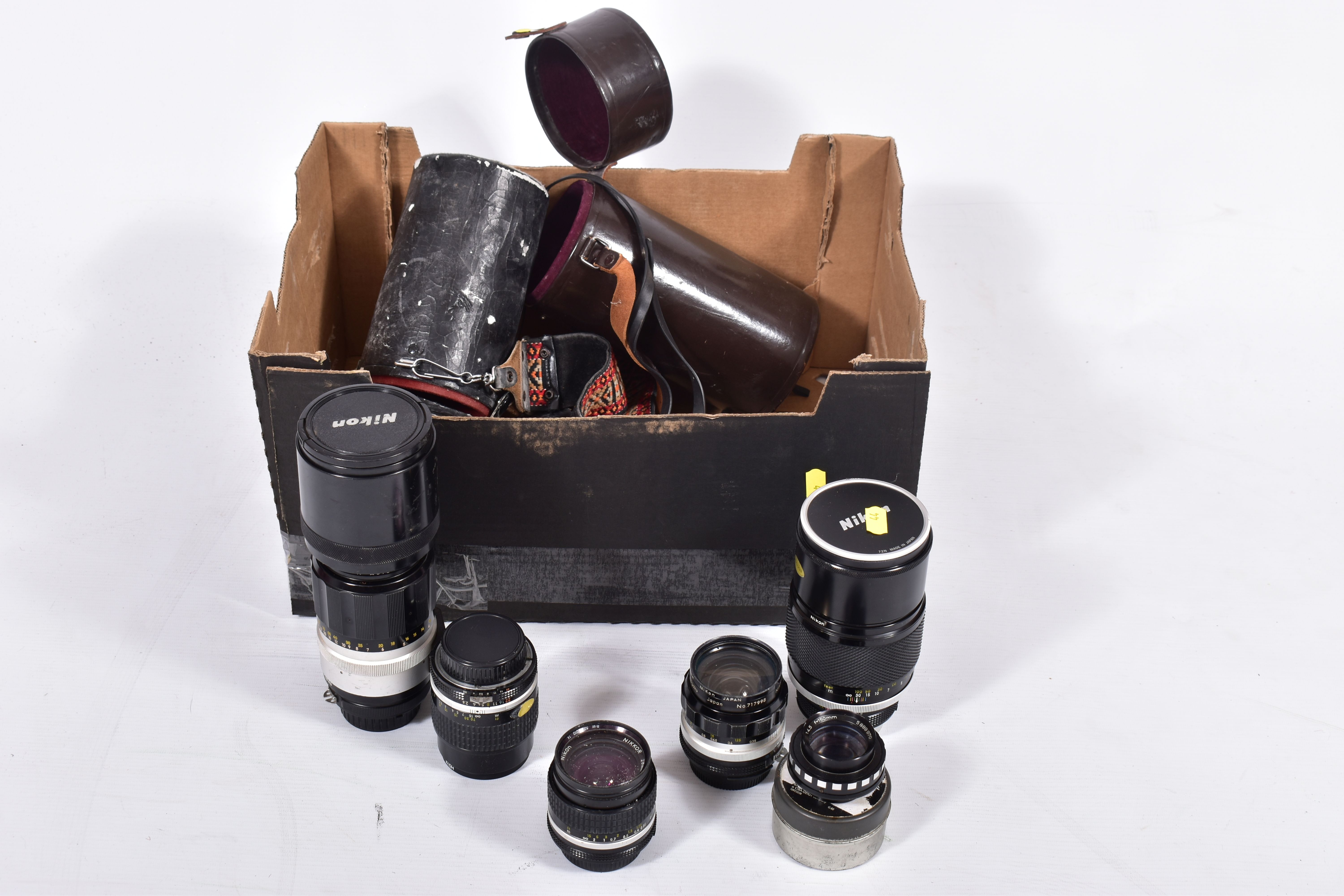 A SMALL TRAY CONTAINING MOSTLY VINTAGE NIKON CAMERA LENSES comprising of a H-Auto 300mm f4.5 in