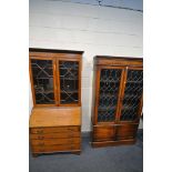 A 20TH CENTURY OAK LEAD GLAZED TWO DOOR BOOKCASE, enclosing three adjustable shelves, above two