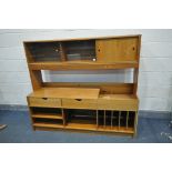 A MID CENTURY SWEEDISH MODULAR EXTENDING WALL UNIT, comprising cupboards, drawers and shelves,