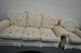 A BEIGE UPHOLSTERED THREE PIECE LOUNGE SUITE, comprising a three seater sofa and a pair of armchairs