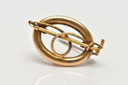 A LATE VICTORIAN HUNTING BROOCH, of an oval openwork form, displaying a riding crop and rope,