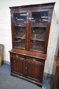 A 20TH CENTURY MAHOGANY BOOKCASE, the top with two glazed doors, enclosing two adjustable shelves,