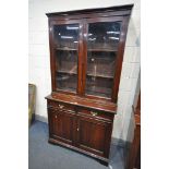 A 20TH CENTURY MAHOGANY BOOKCASE, the top with two glazed doors, enclosing two adjustable shelves,