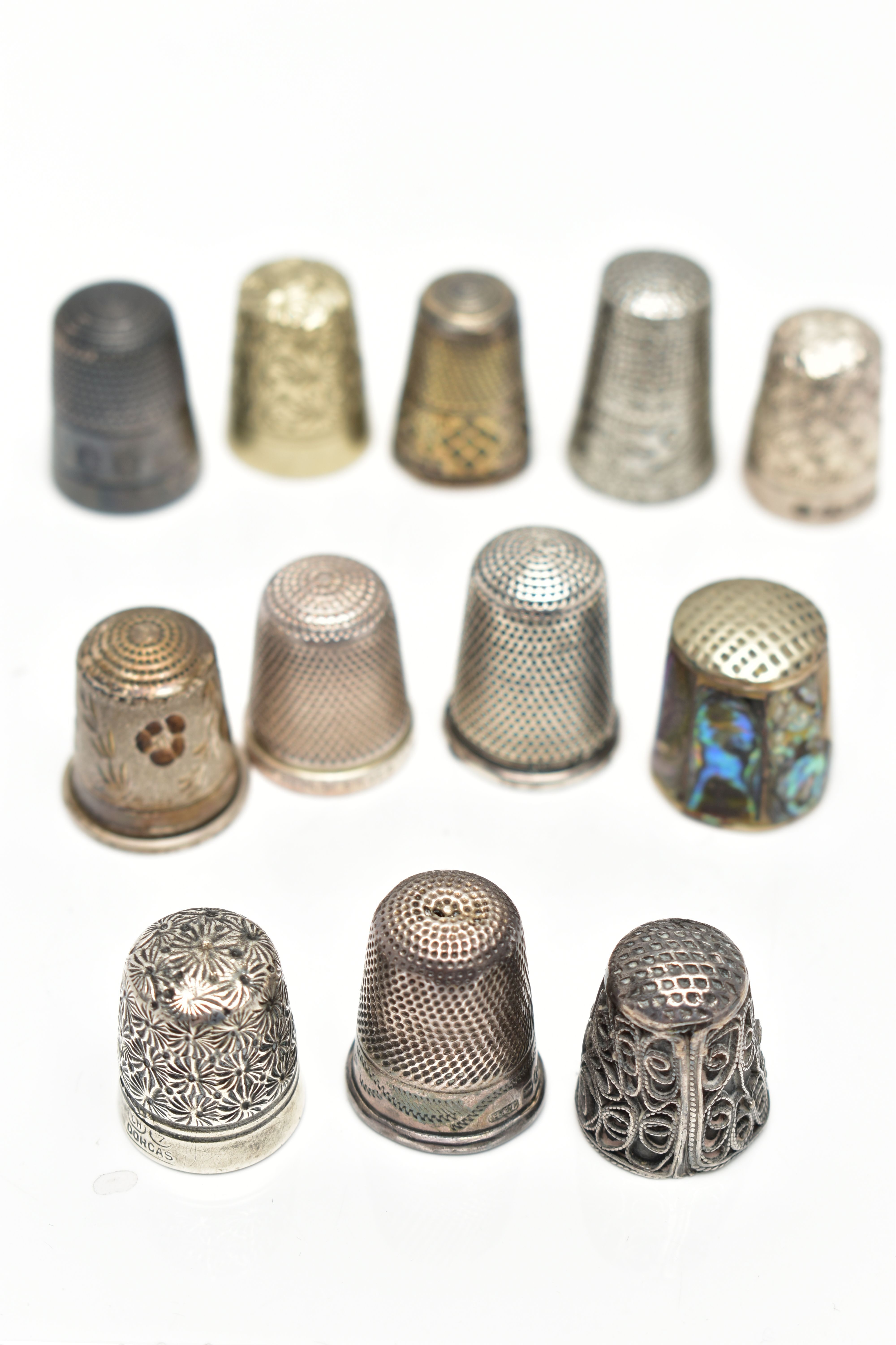 TWELVE THIMBLES, to include six with silver hallmarks, approximate gross weight 27.0 grams, six