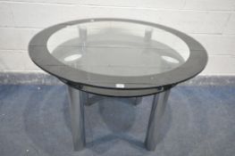 A GLASS CIRCULAR DINING TABLE, on chrome legs, with a smaller glass undershelf, diameter 110cm x
