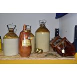 THREE MITCHELLS AND BUTLER LTD STONEWARE BEER JARS WITH METAL HANDLES, heights approx. 49cm and 37cm