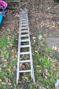 AN ALUMINIUM DOUBLE EXTENSION LADDER with 15 rungs to each 4m section along with a Standoff