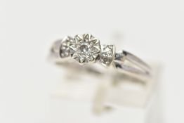 A 9CT WHITE GOLD DIAMOND RING, centering on an illusion set round brilliant cut diamond, flanked