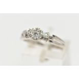 A 9CT WHITE GOLD DIAMOND RING, centering on an illusion set round brilliant cut diamond, flanked