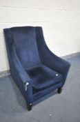 A BLUE VELVET ARMCHAIR