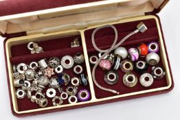 A SMALL TRAVEL JEWELLERY BOX WITH CHARMS, burgundy jewellery box filled with white metal and glass